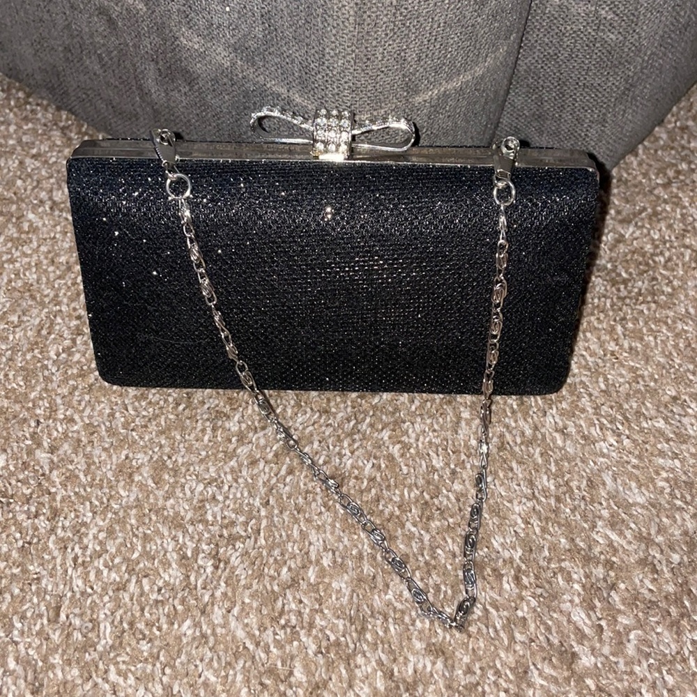 Small black and silver wristlet. Sequenced now clip on top.